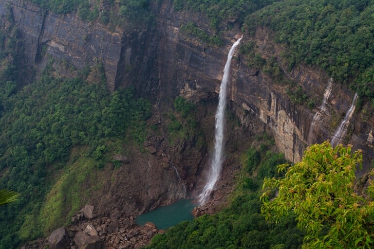 Listen to the roar of water falling into the massive Nohkalikai falls